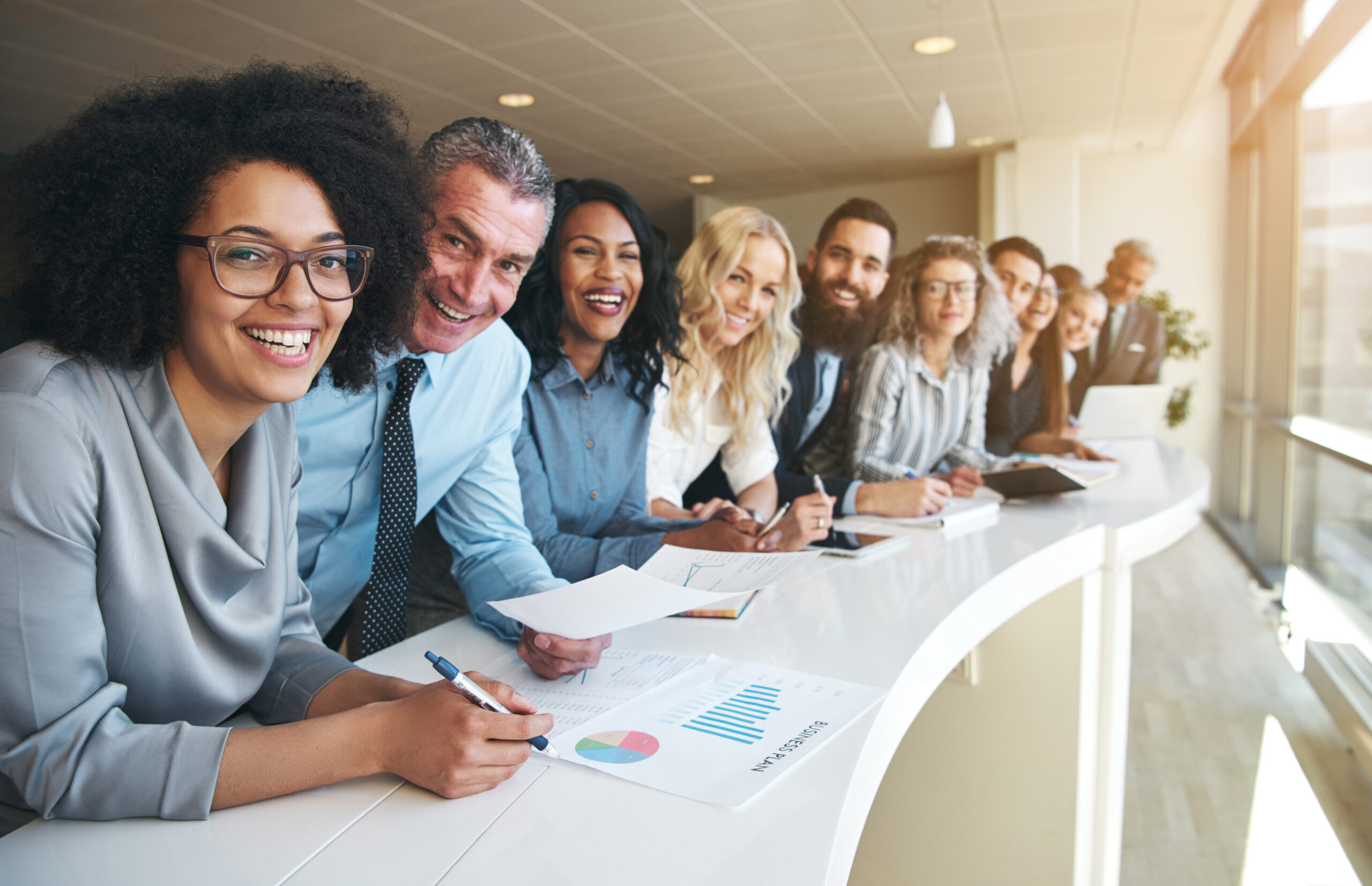 Cheerful multiracial colleagues looking at camera in office Cheerful multiracial colleagues looking at camera in office